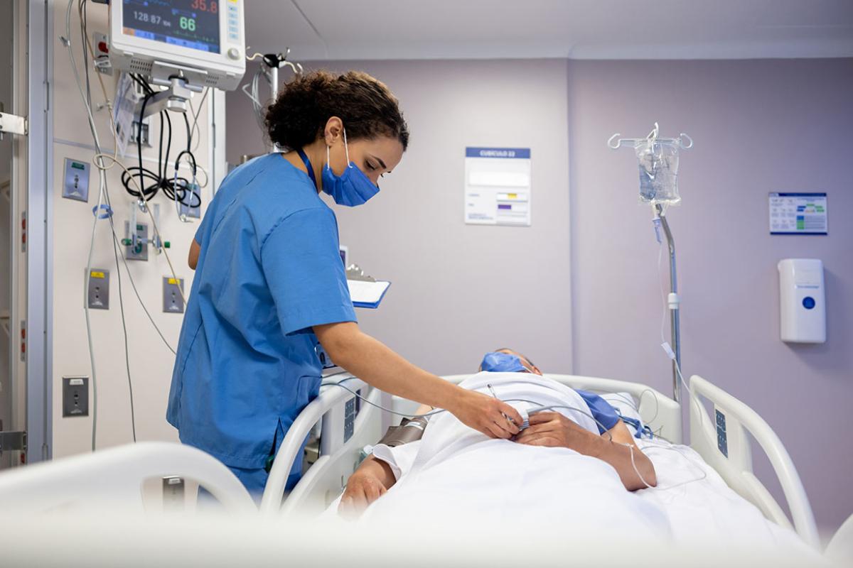 Health care worker checking on a patient at the hospital 