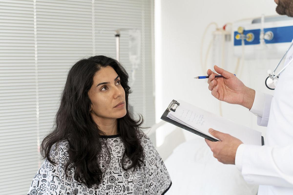 Patient in hospital room in discussion with physician