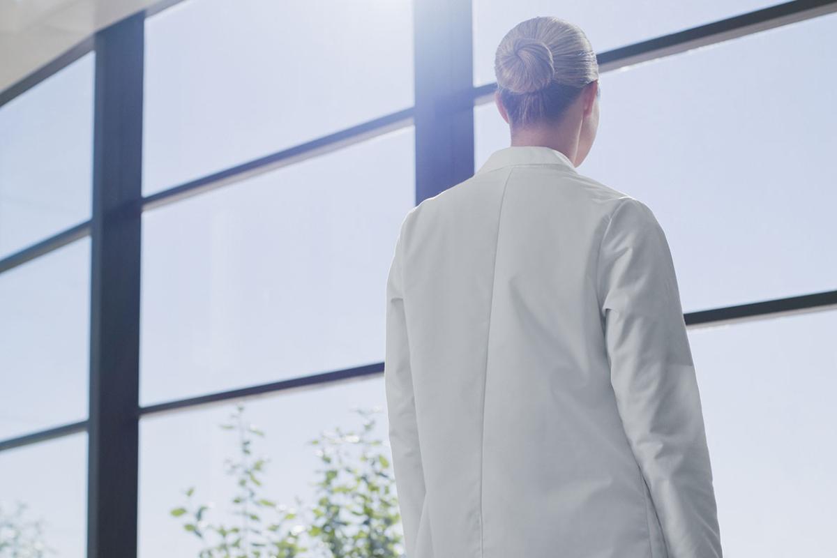 Physician looking out a window