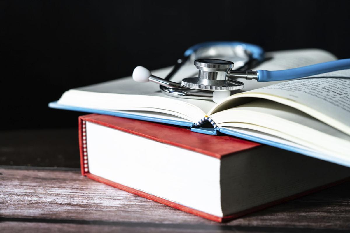 Stacked books with stethoscope on top