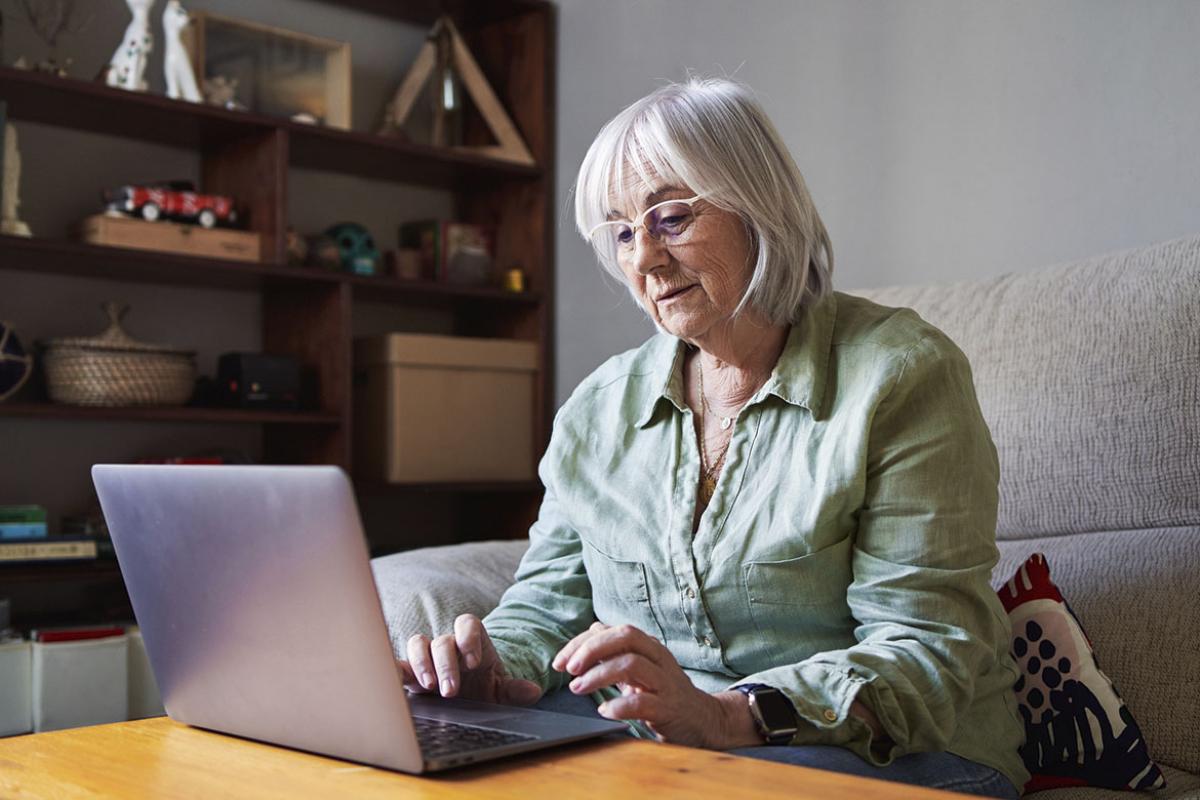 Senior person working at laptop