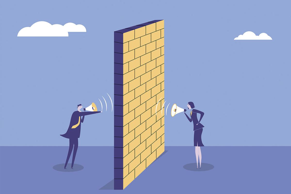 Businesspeople with megaphones separated by partition wall 