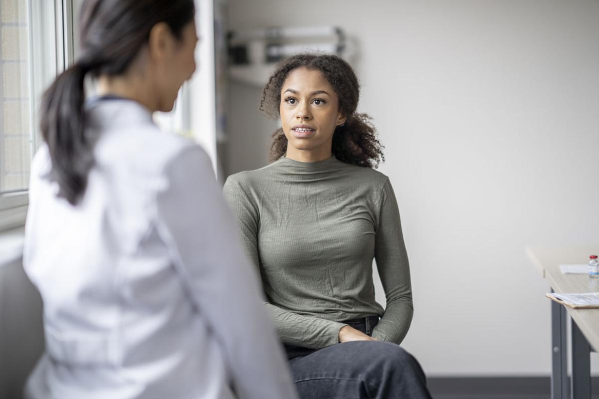 Patient speaking with doctor in an exam room
