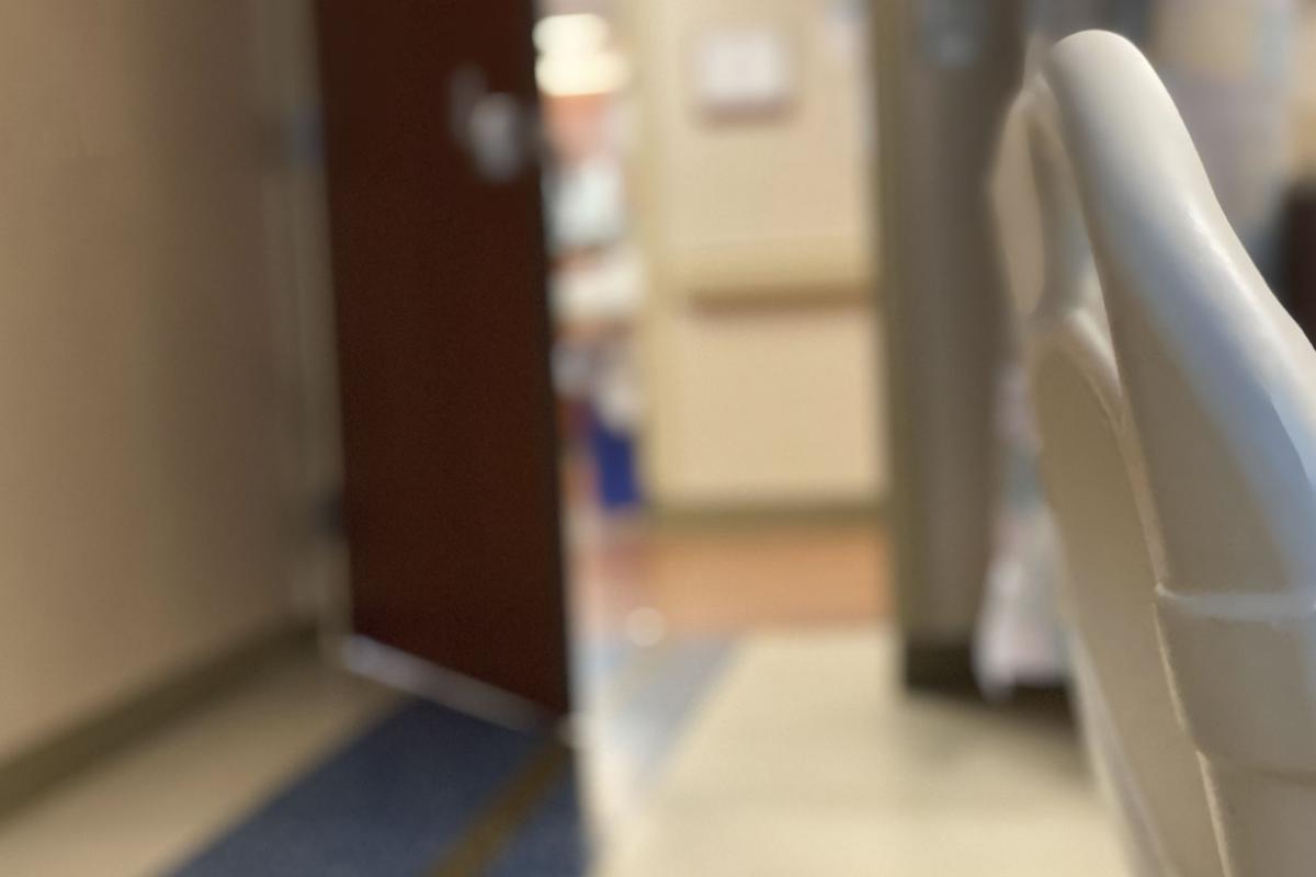 View of hospital hallway and nurses’ station from patient room