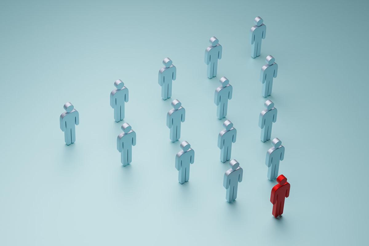 Group of figures shaped in a triangle with one figure a different color