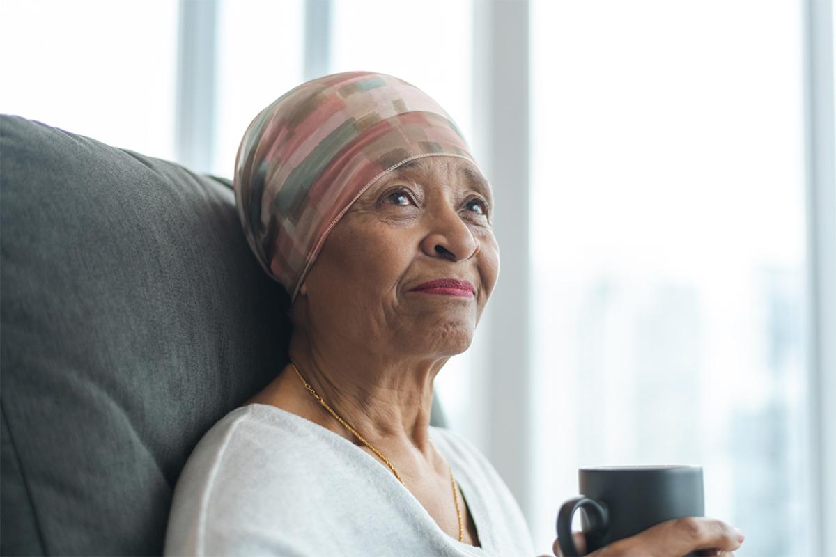 Contemplative senior woman wearing a scarf on head