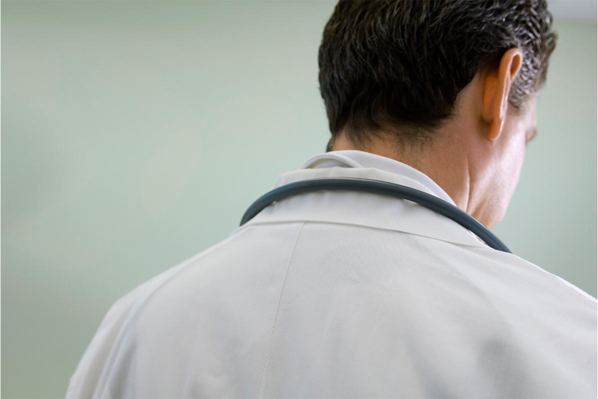 Doctor contemplatively looking down