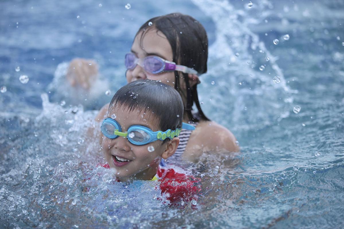 Two happy children swimming