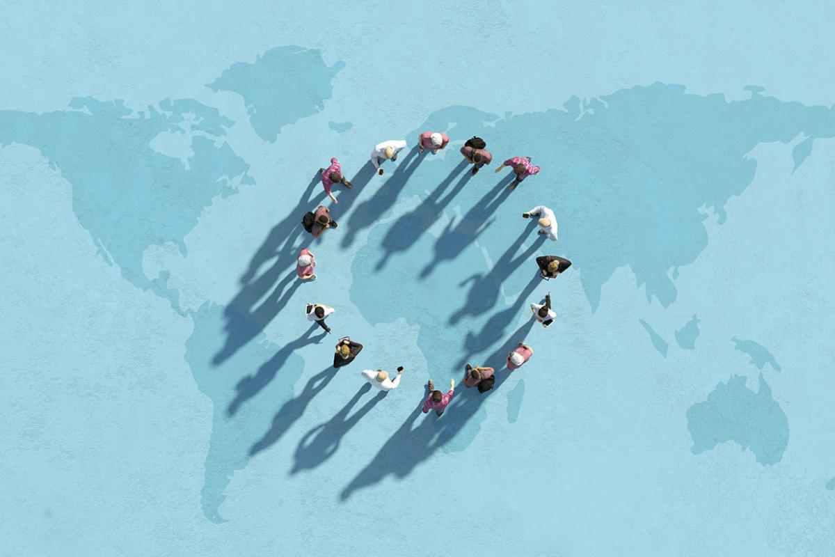 Group of people forming circle on world map