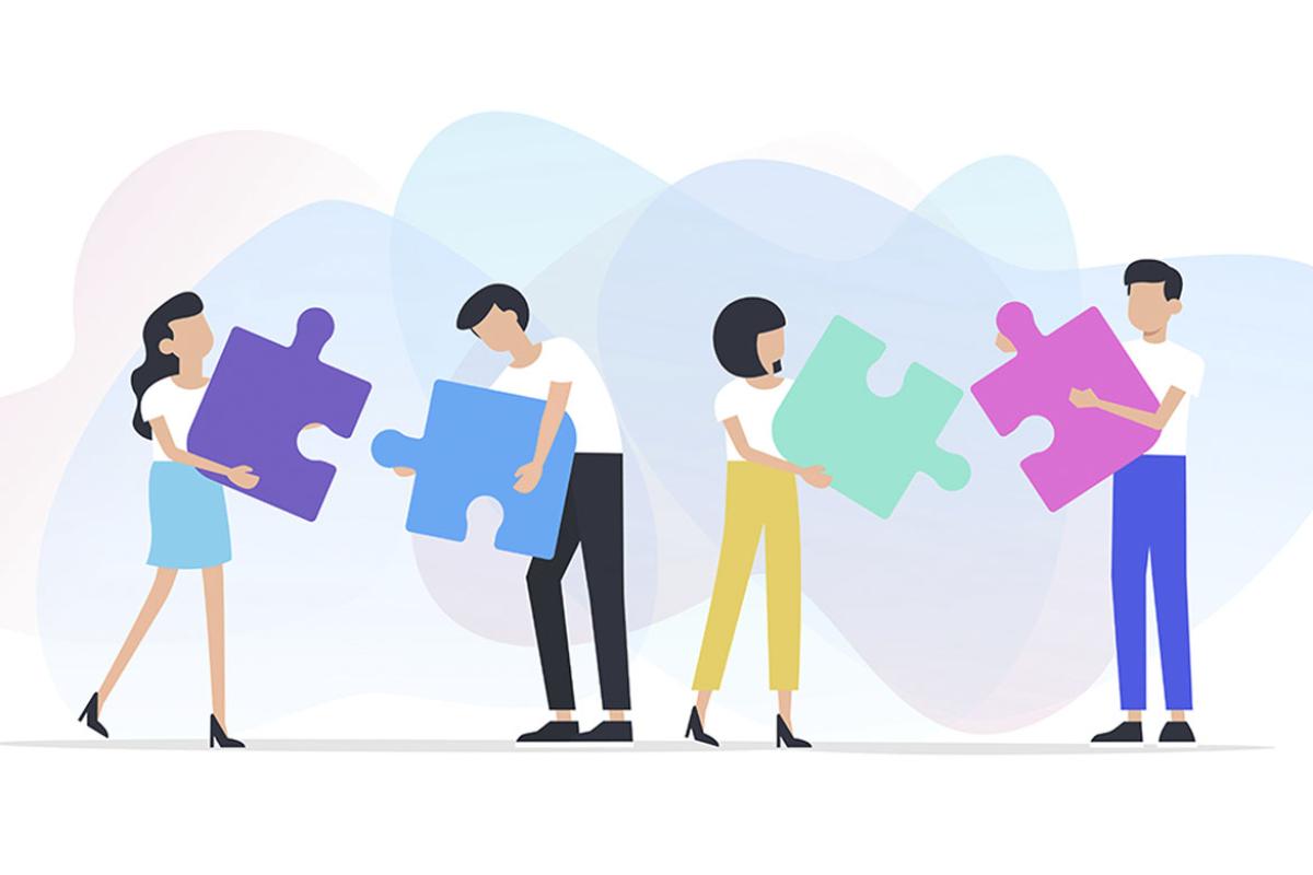 Four figures holding large puzzle pieces