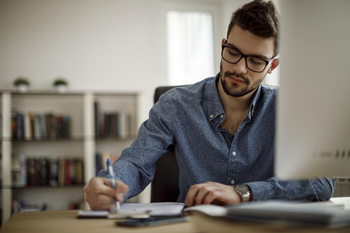 Man filling out a document