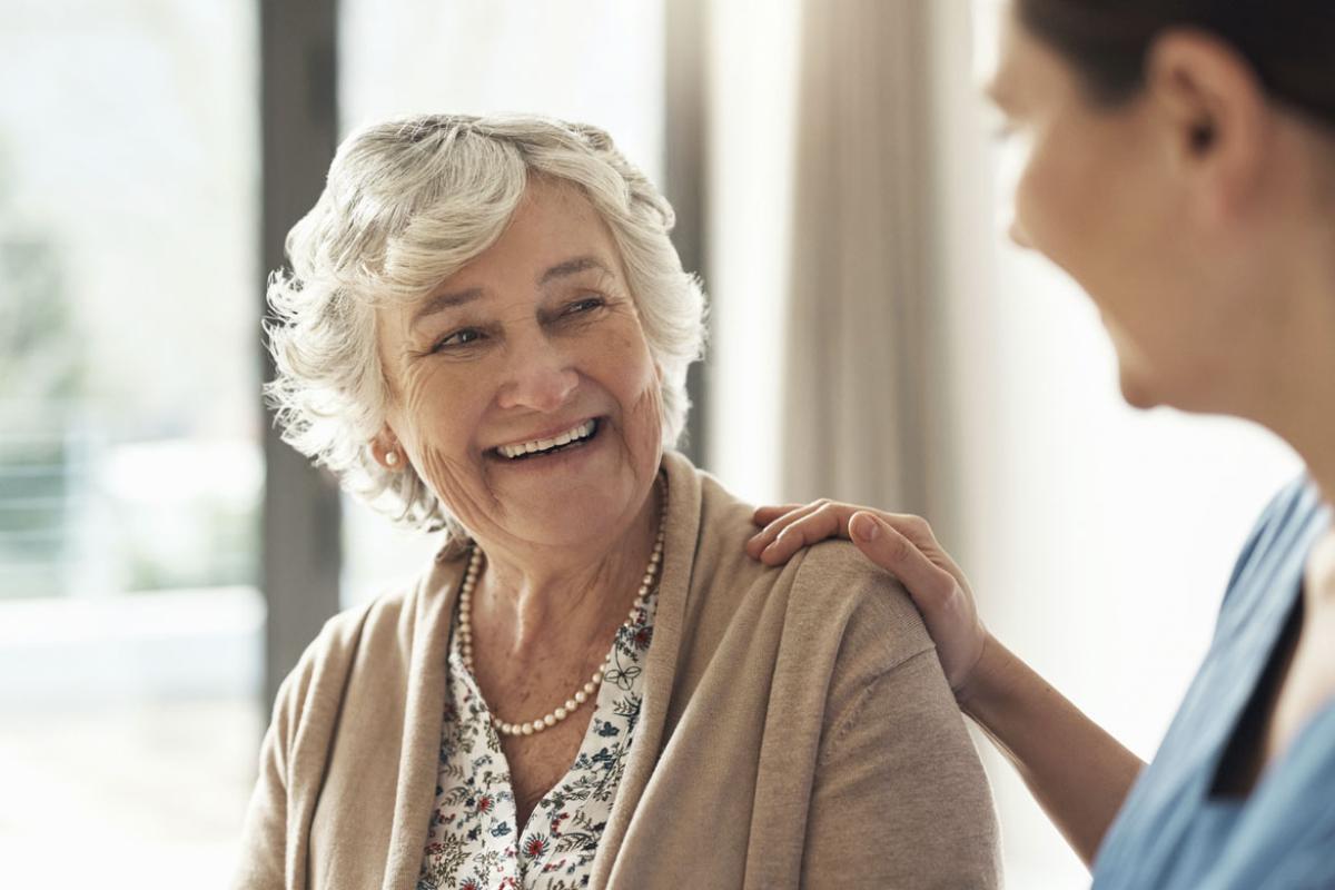 Smiling senior patient with health care worker