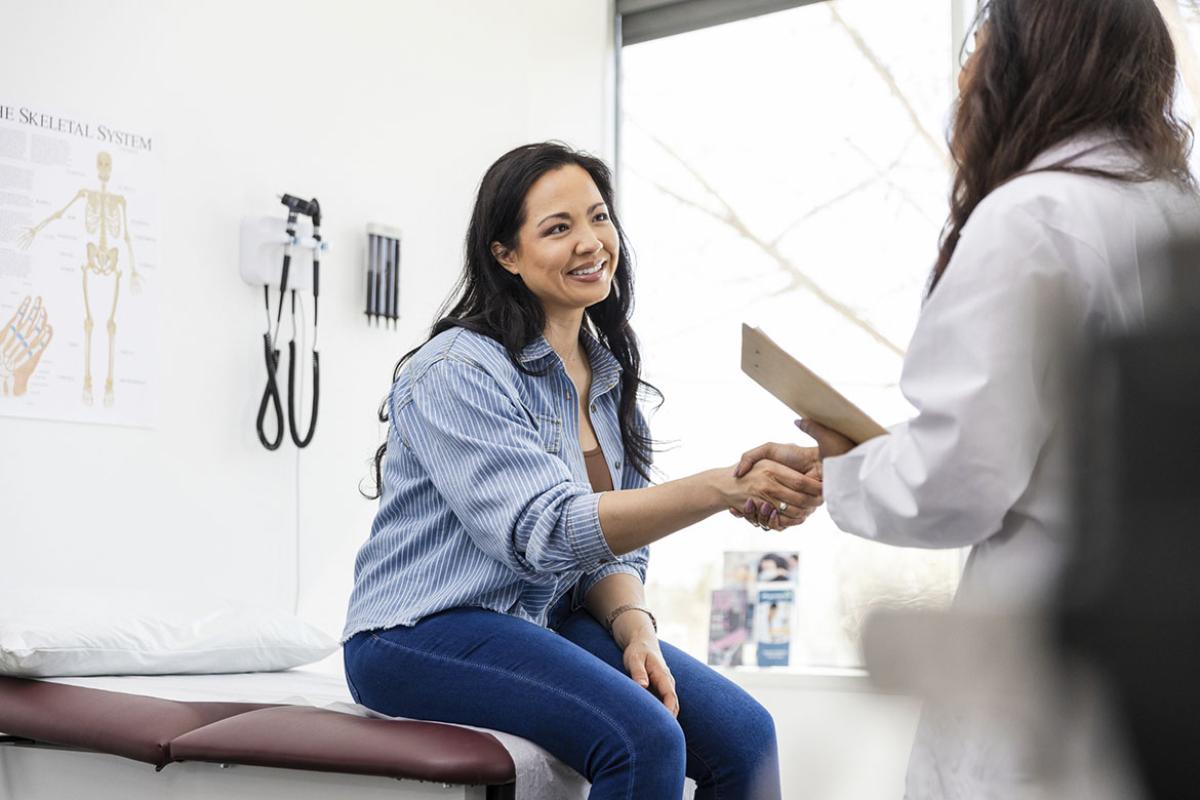 Smiling patient shaking hands with physician