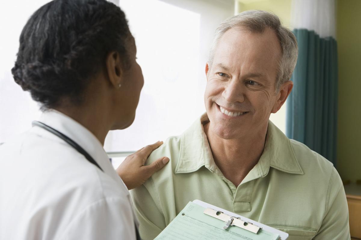 Physician placing hand on patient shoulder