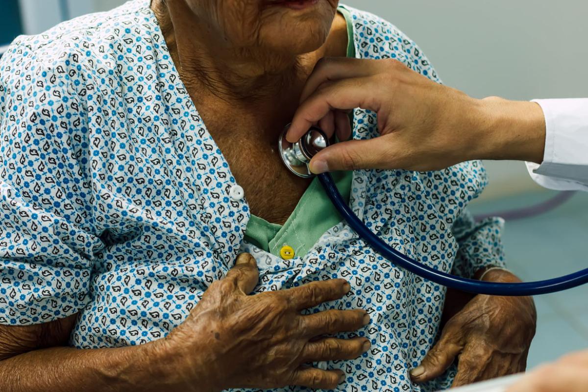 Doctor listening to heart beat and breathing of patient