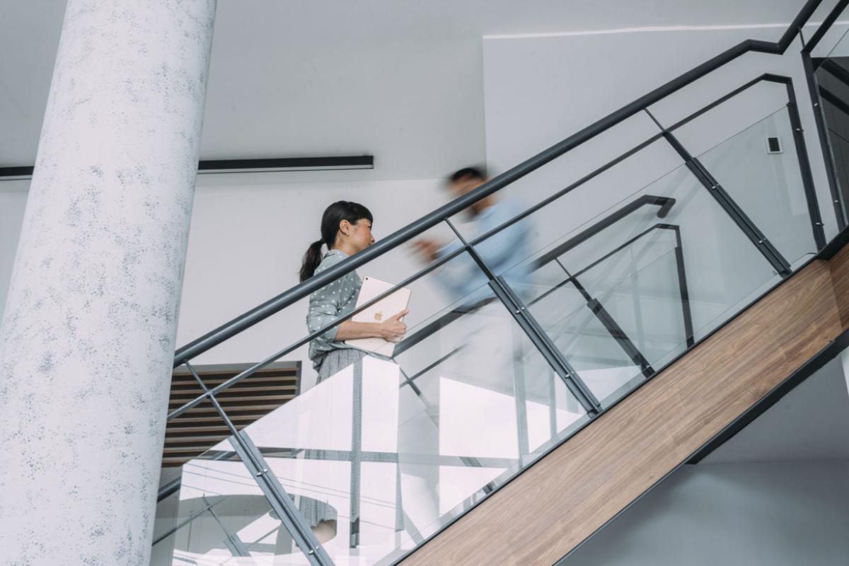Professionals walking up and down a busy stairwell