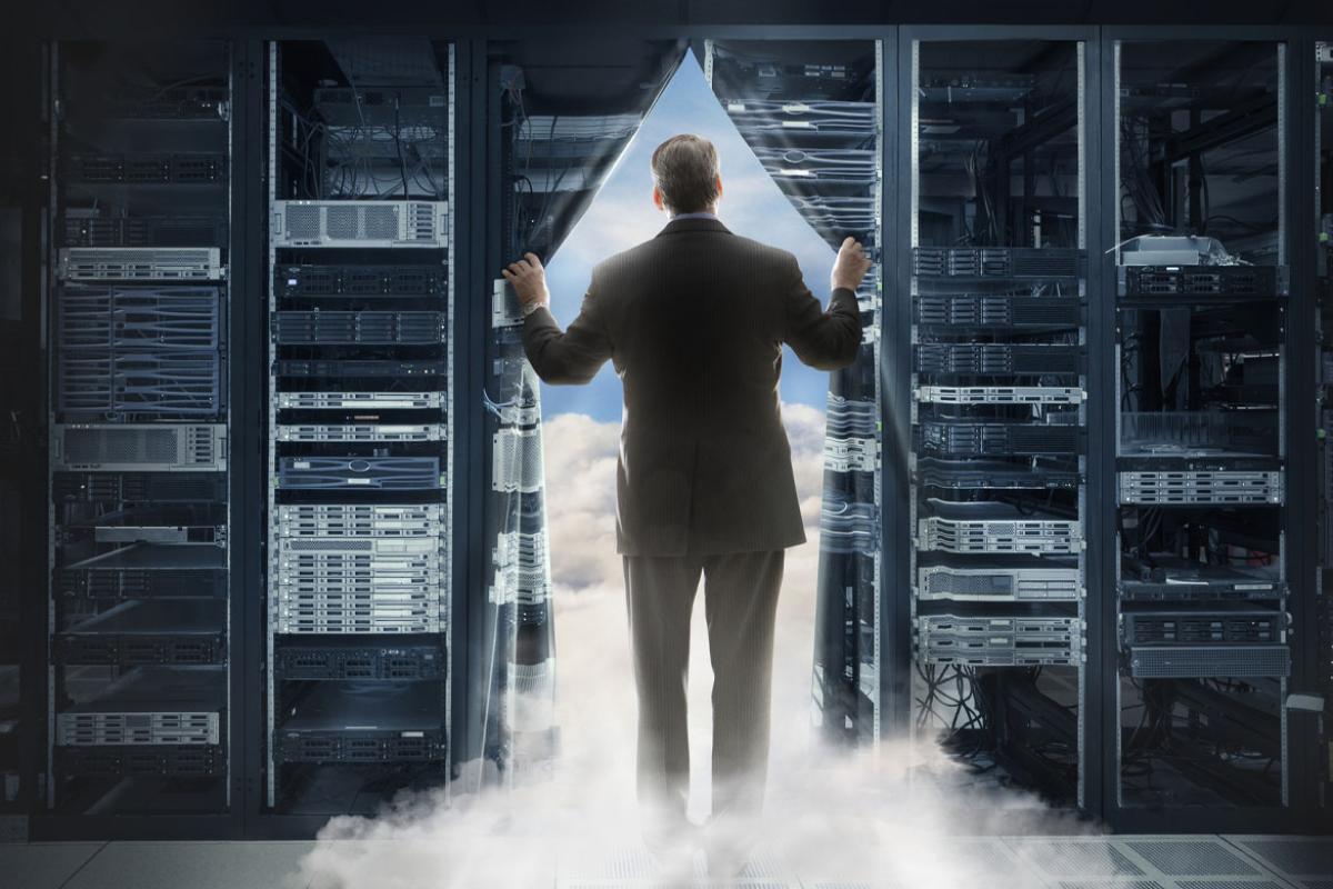 Businessperson pulling back curtain to clouds