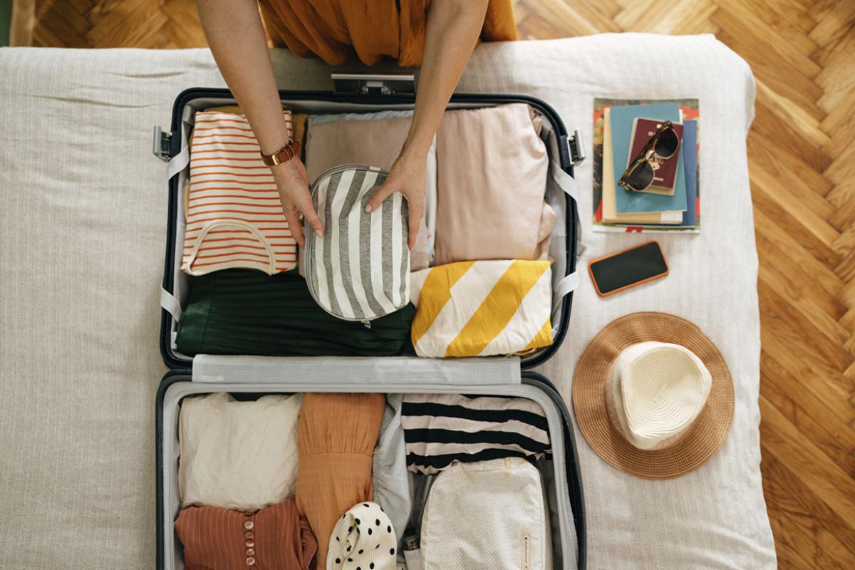 Person packing up a suitcase
