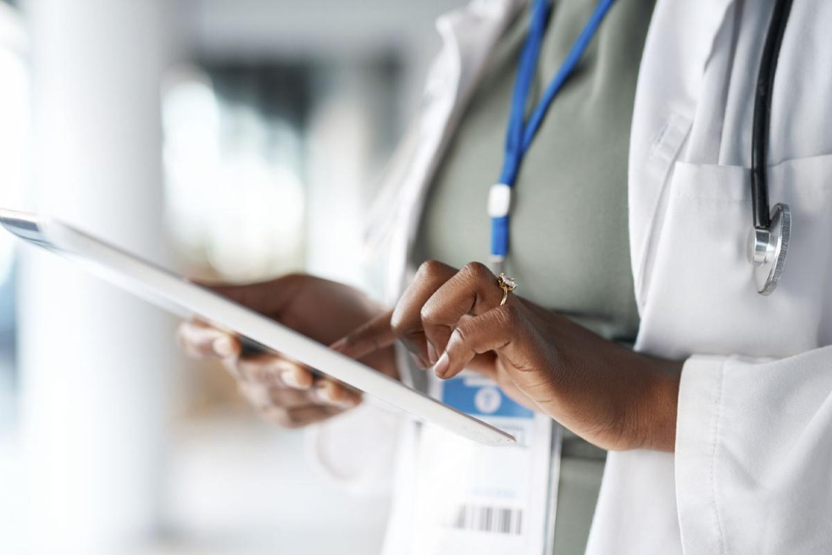 Two physicians scrolling on a tablet