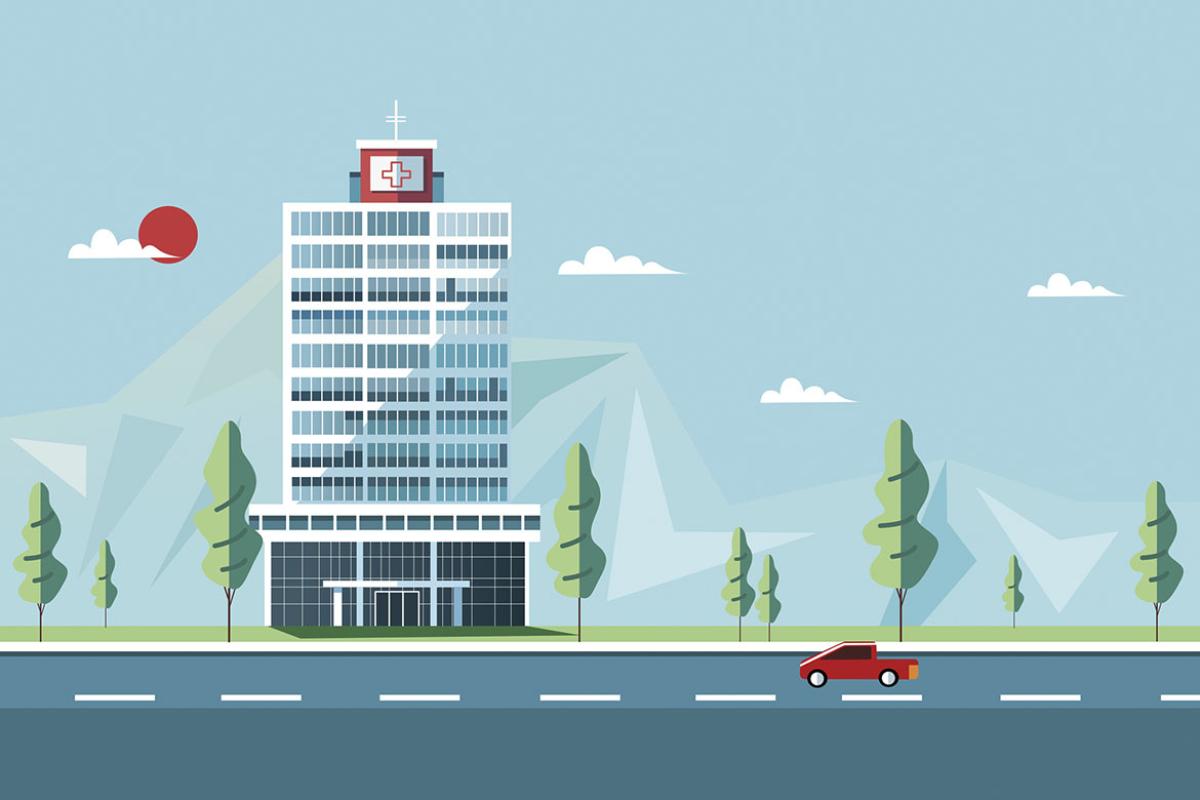 Hospital among a road, trees and mountains