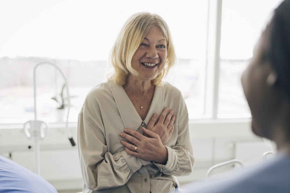 Smiling patient in conversation with health care worker