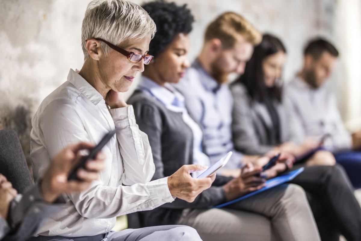Group of people looking at their cell phones