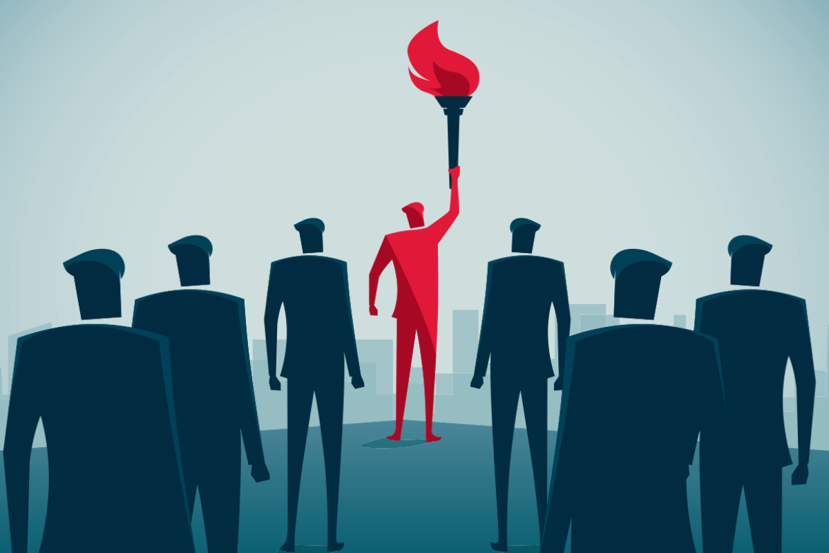 Figure holds a torch in front of a group