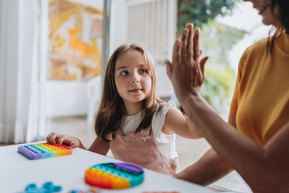 Child gives caregiver a high five