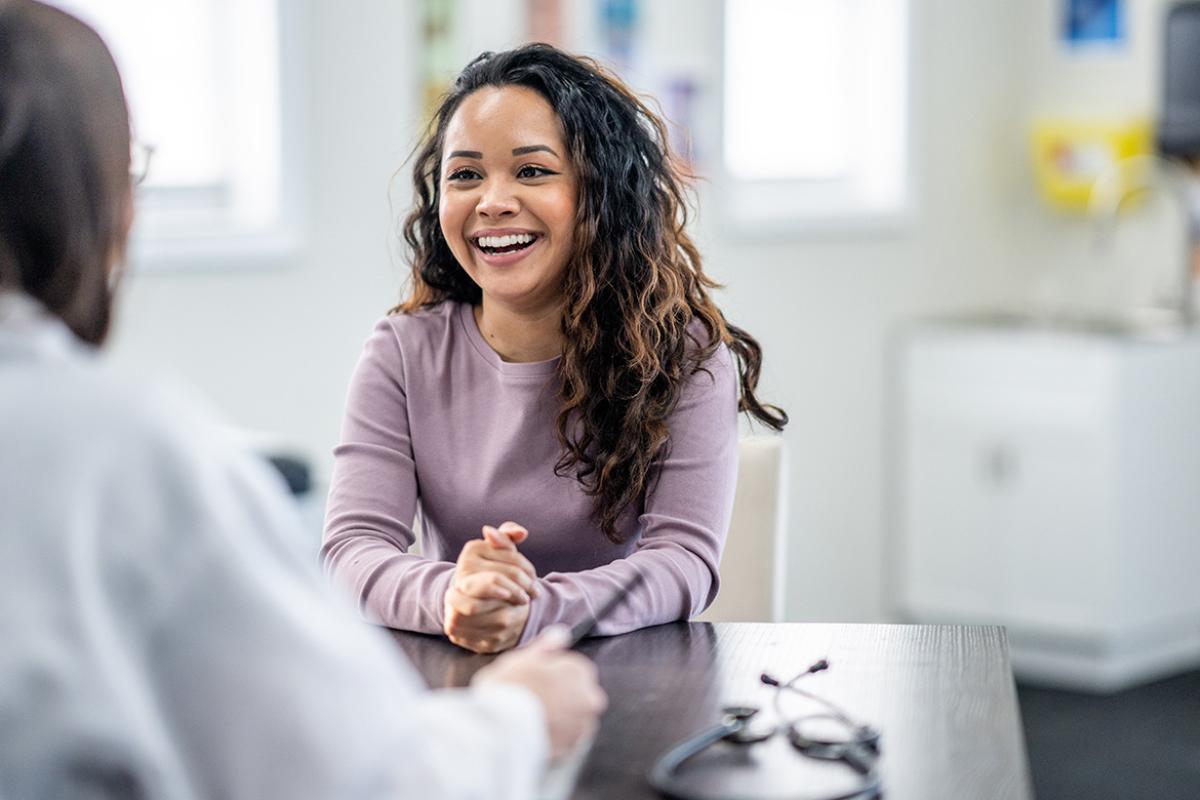 Smiling patient in conversation with doctor