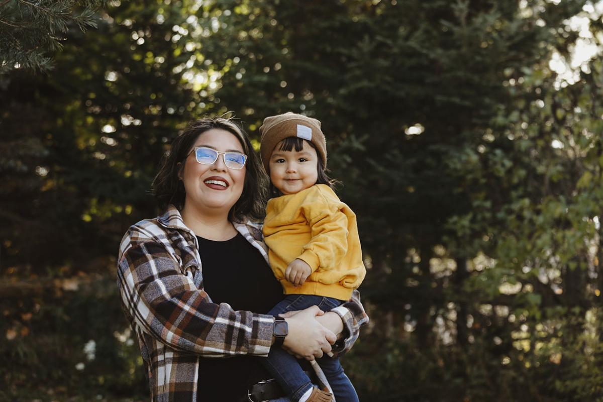 Smiling mother holding child