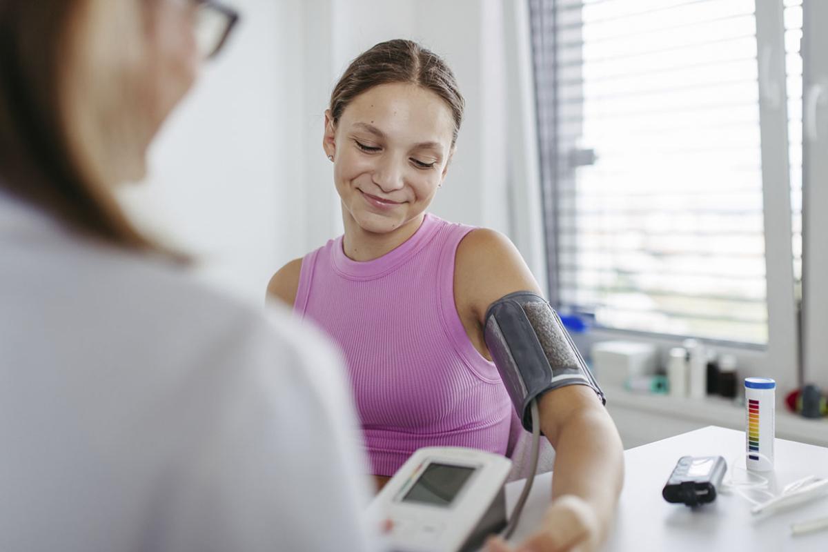 Doctor measuring a patient's blood pressure in clinic