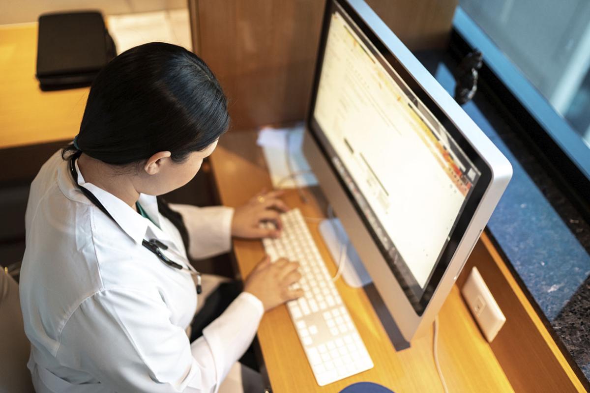 Doctor using desktop computer