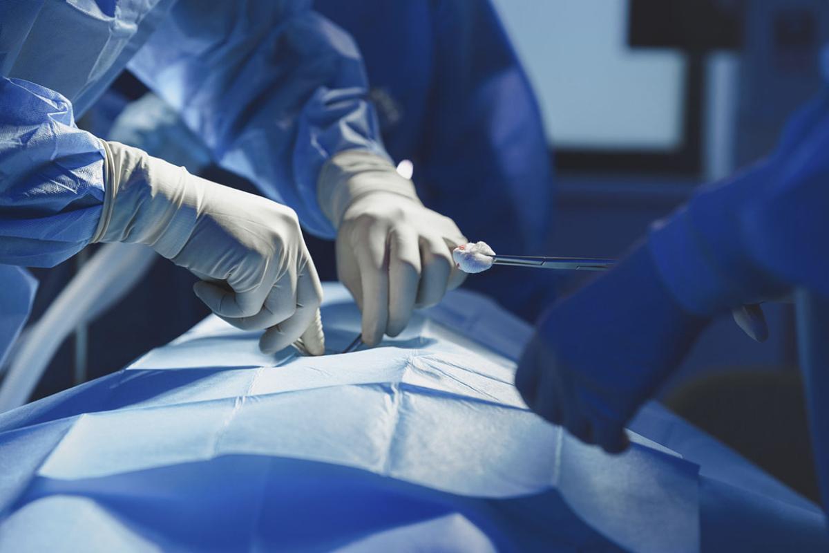 Close-up of surgeon with nurse and and assistant during operation