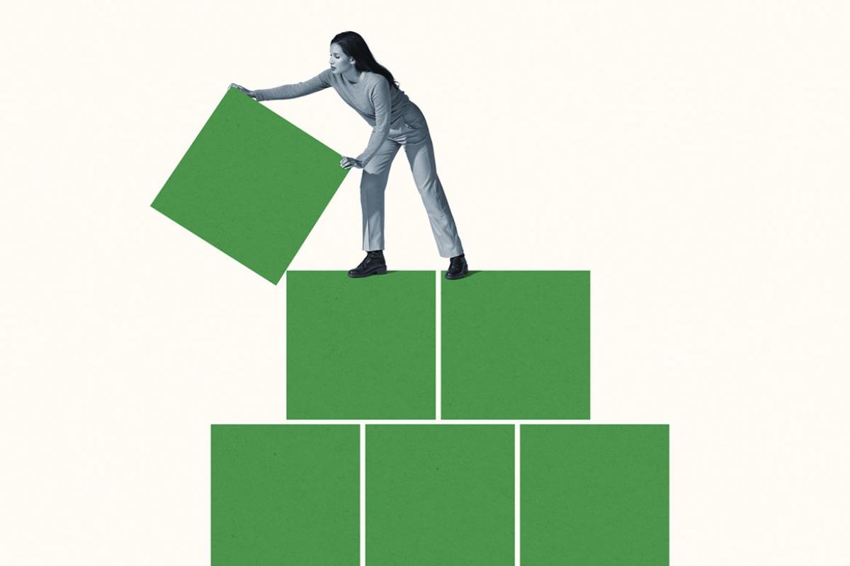 Woman building block pyramid