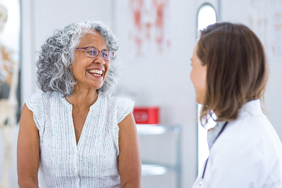 Older female patient consulting with physician.