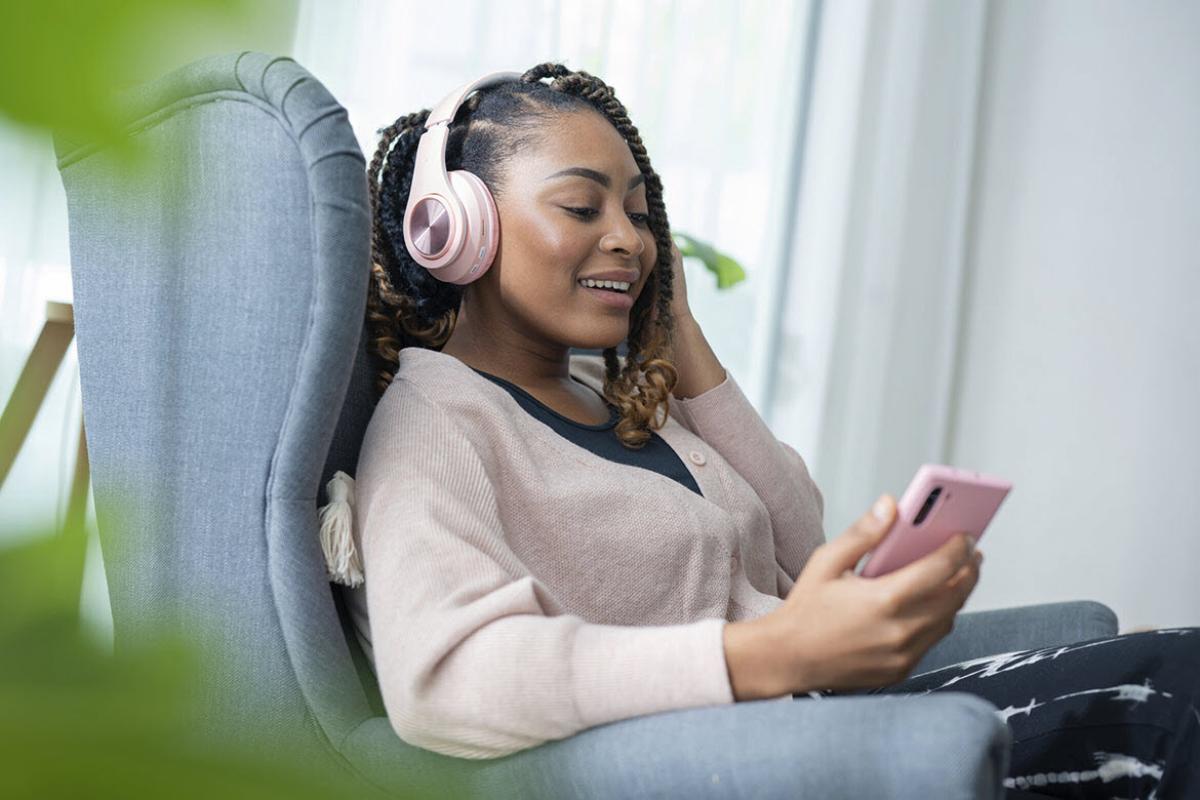 Woman wearing headphones, listening to podcast