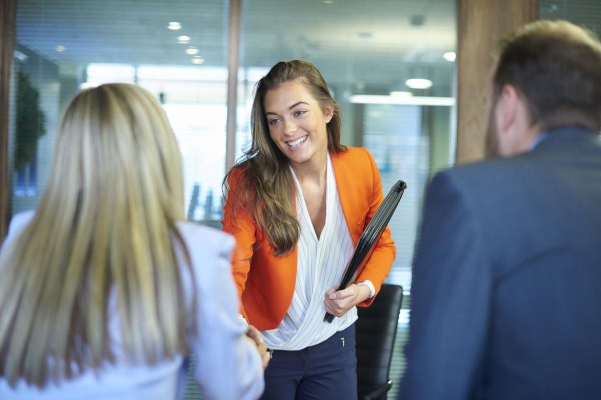 Smiling candidate shakes hands at a job interview