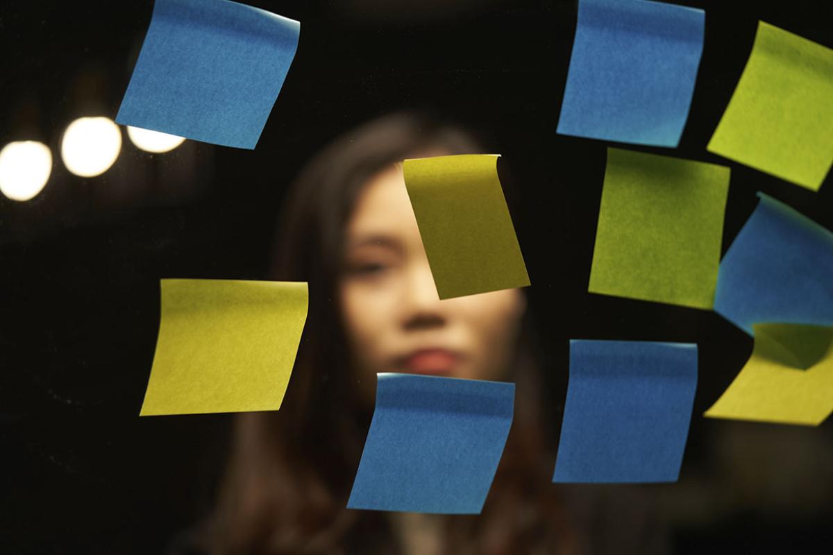 Person looks at sticky notes