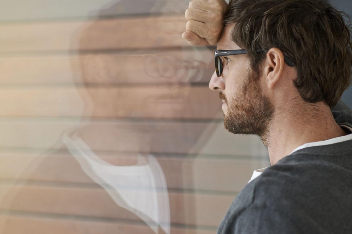 Man leans against a glass window