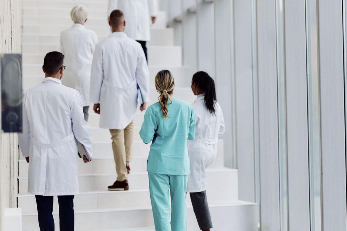 Health care team ascending a staircase