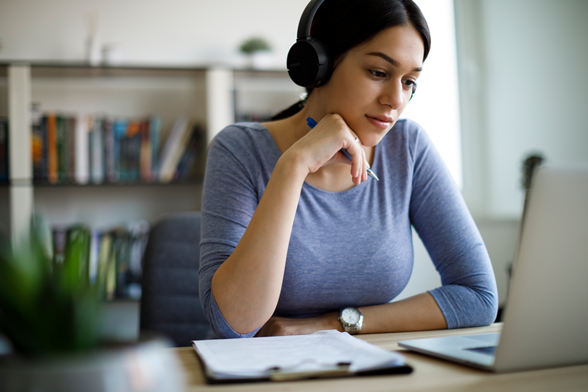 Person wearing headphones working in front of laptop