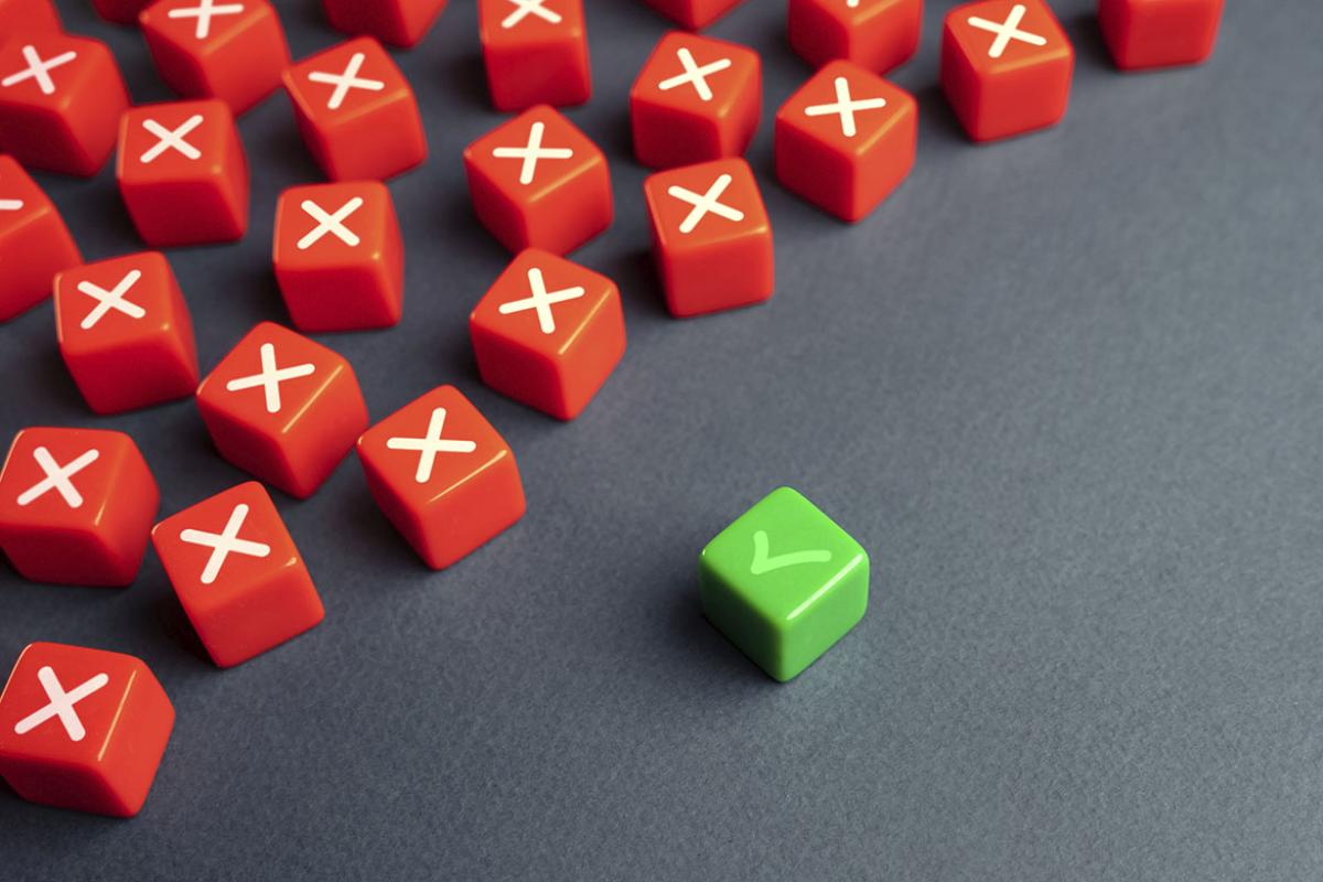 One box marked with a check surrounded by many boxes marked with an x