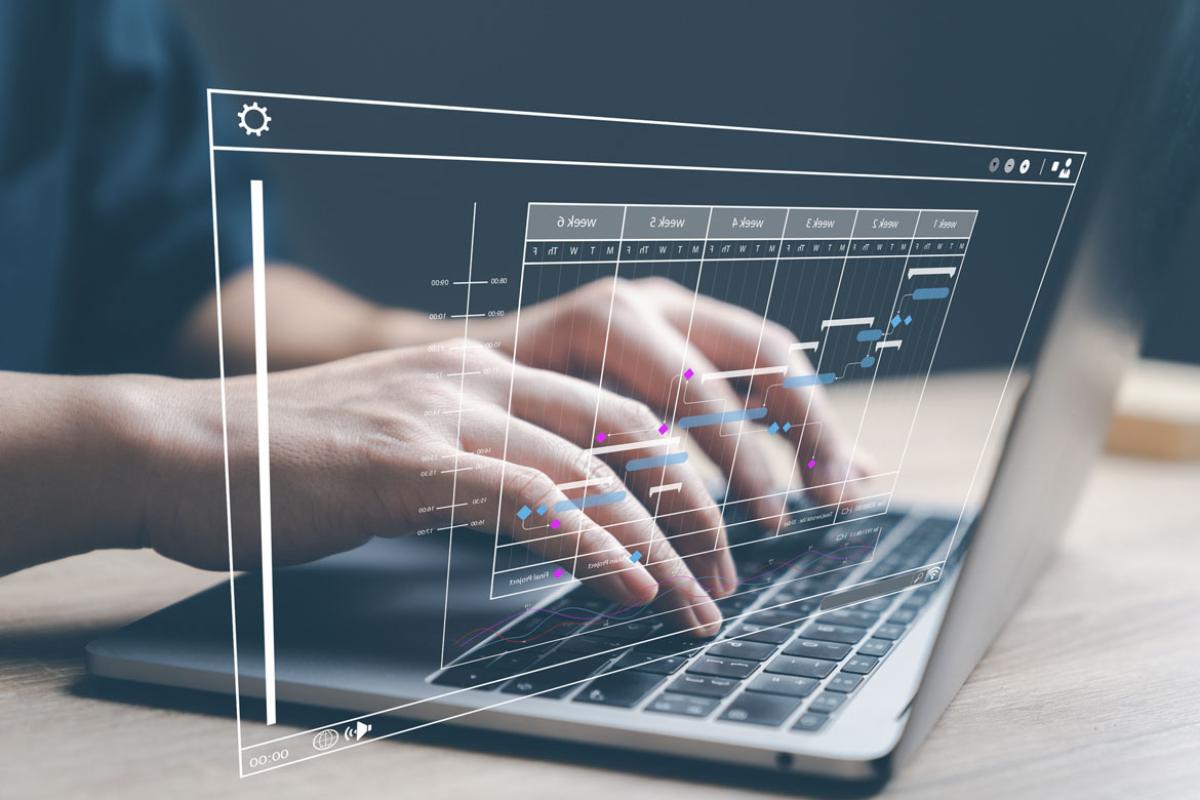Hands typing on a laptop