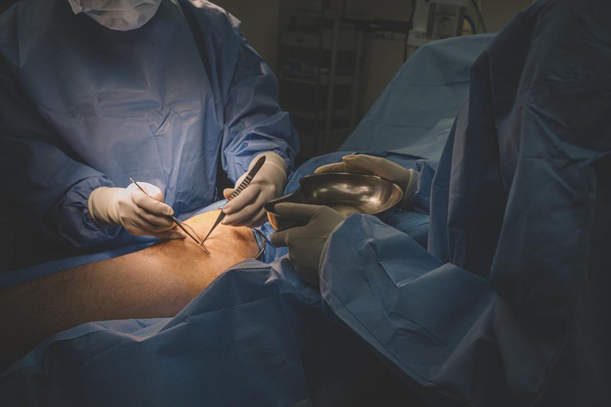 Surgeon operating on a patient's leg 