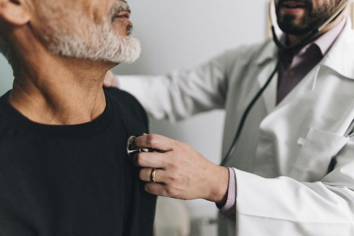 Doctor exams patient