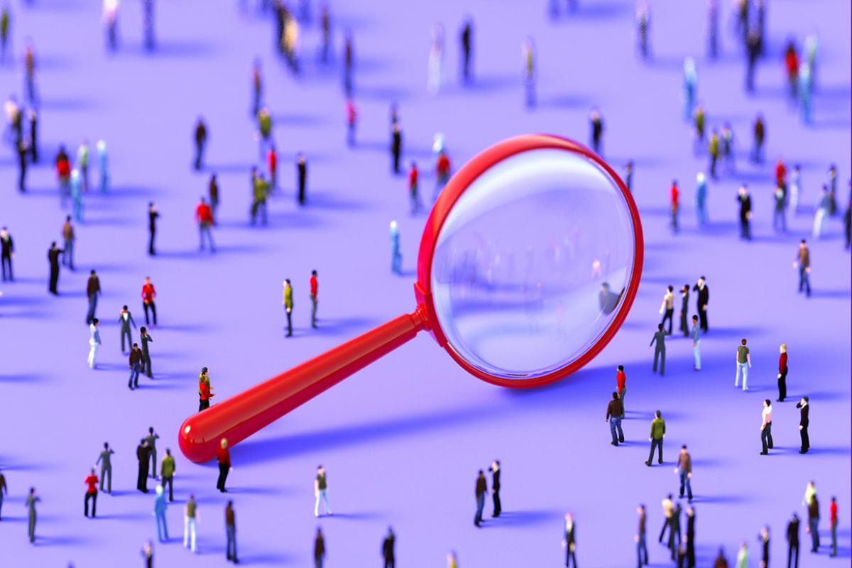 Giant magnifying glass amid a crowd