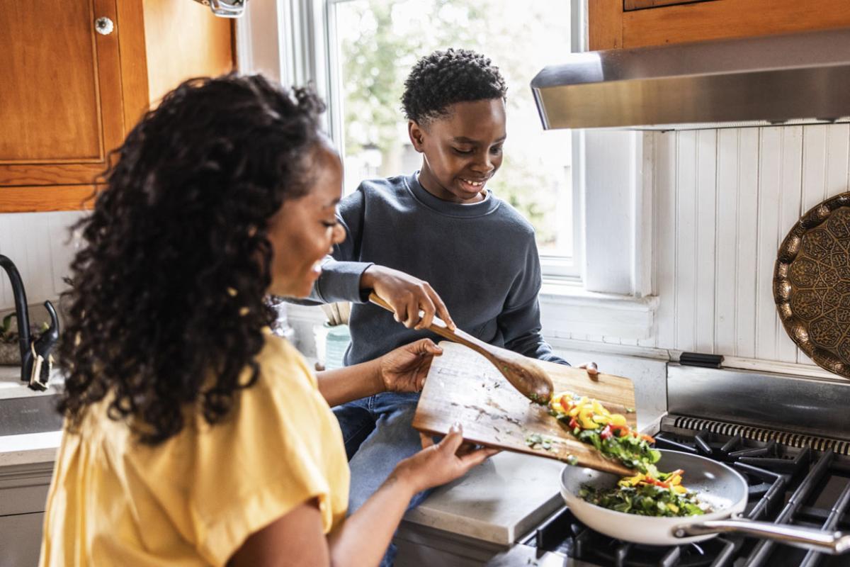 Mother and child preparing dinner together
