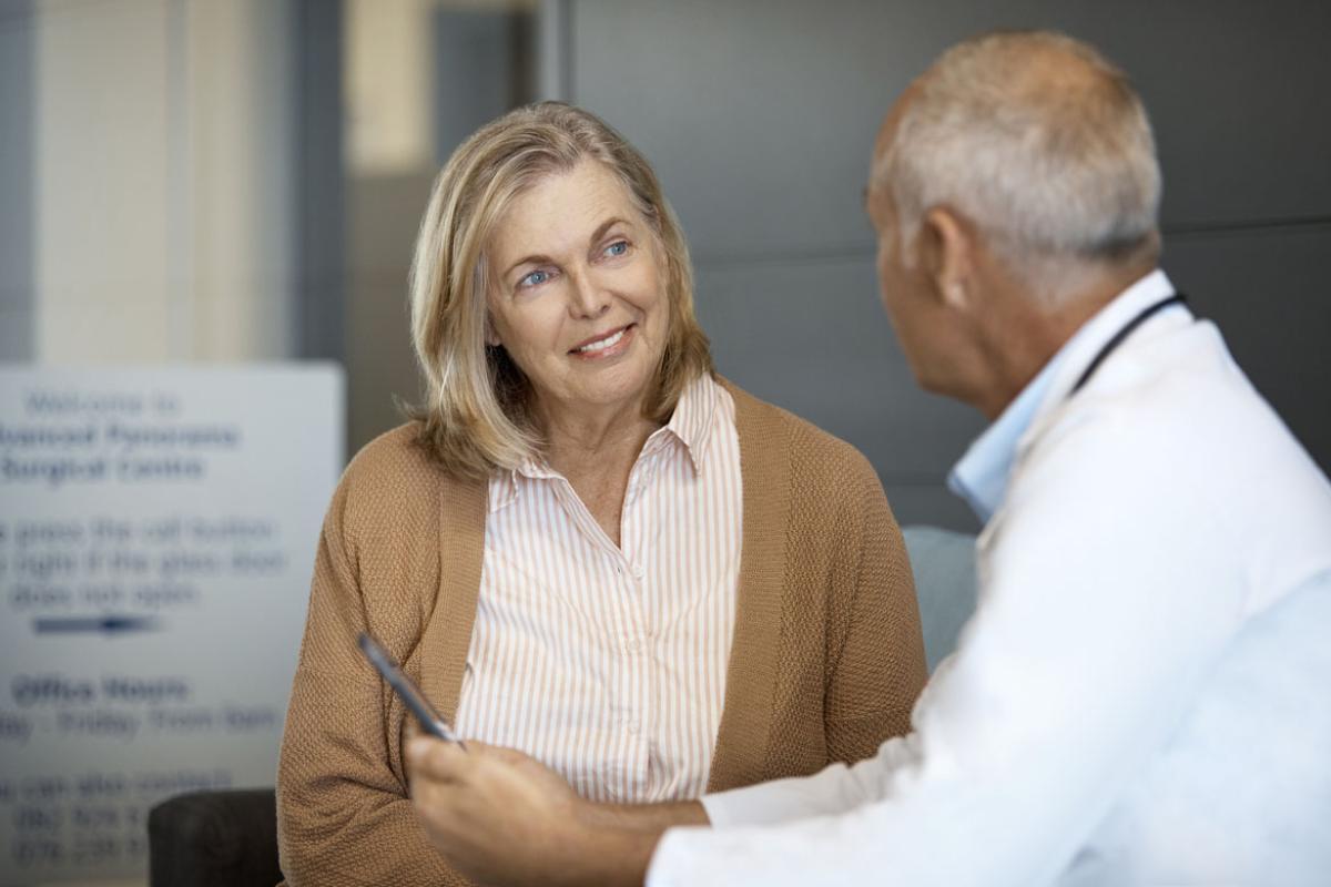 Smiling patient listening to doctor
