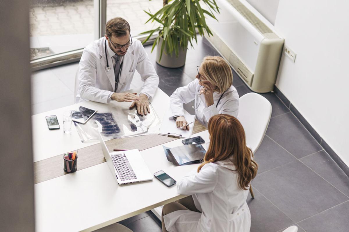 Doctors in discussion in hospital meeting room