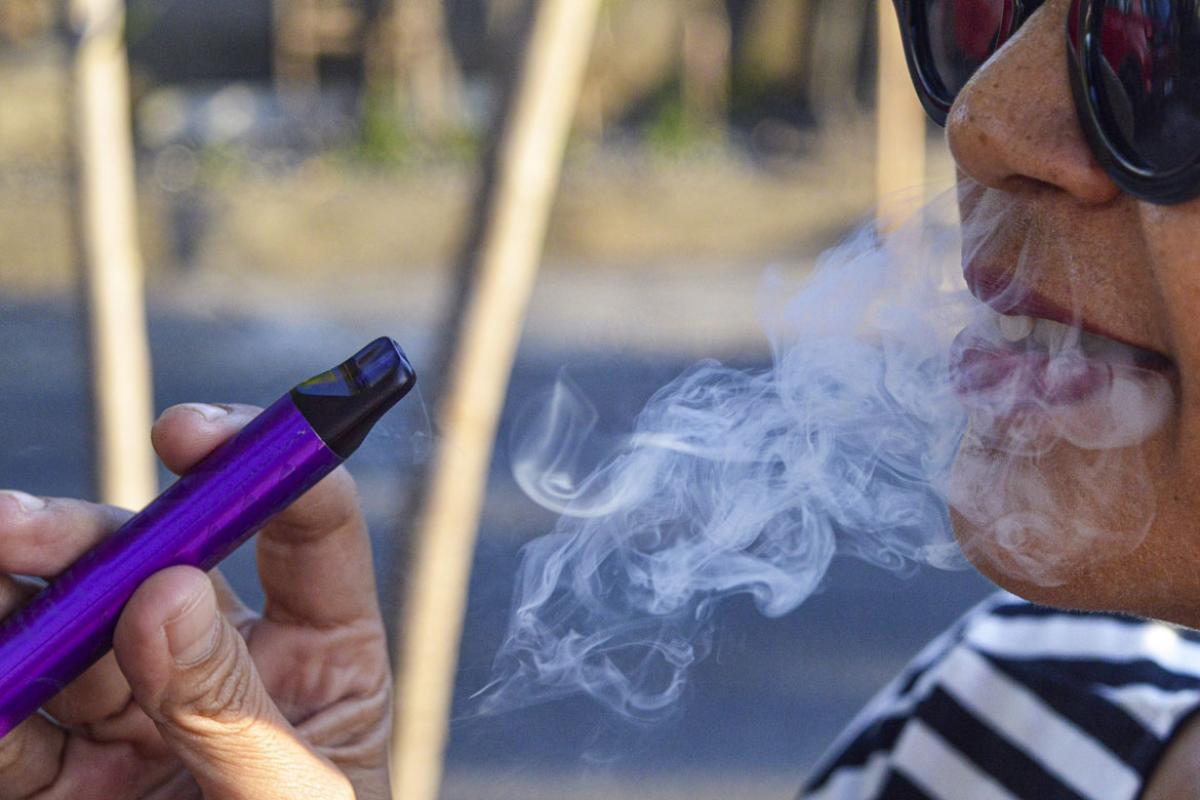 Person uses an e-cigarette